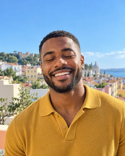 Before: Eyes closed mid-smile, then opened with Glowly. The rooftop, the shirt and the light are unchanged.